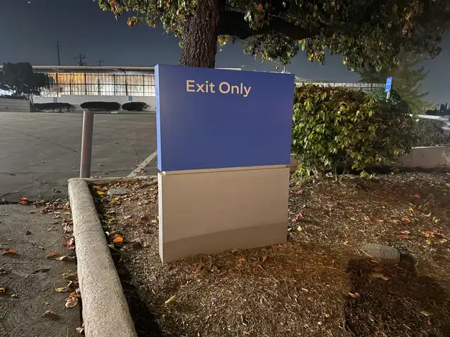 Exit Only directional monument sign at a parking lot exit