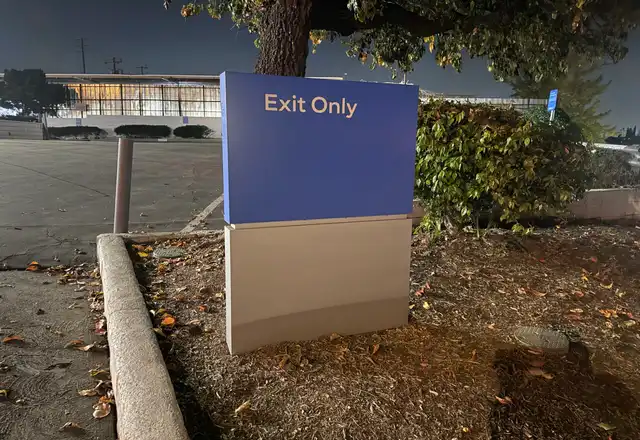 Exit Only directional monument sign at a parking lot exit